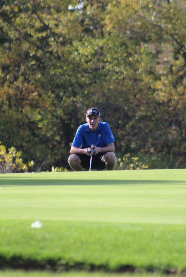 Stare down: Tyler Moran ‘19 lining up his put. Moran shot an 83 at the state tournament. “I have put so much time into this sport and it has finally all all paid off,” he said. 