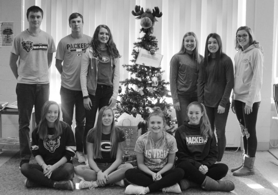 Merry+Christmas+from+Galena%E2%80%99s+NHS+and+FFA.+Chance+Wills+%E2%80%9820%2C+Conner+Einsweiller+%E2%80%9819%2C+Sophia+Heisler+%E2%80%9819%2C+Lizzy+Eaton+%E2%80%9820%2C+Samantha+Stoffregen+%E2%80%9819%2C+Kenzie+Casper+%E2%80%9820%2C+Evelyn+Larson+%E2%80%9819%2C+Shea+Curran+%E2%80%9819%2C+Sawyer+Quick+%E2%80%9819%2C+and+Abby+Moyer+%E2%80%9819+gather+around+the+tree+they+created+for+Christmas+gift+donations.+GHS+students+took+a+tag+off+the+tree%2C+and+brought+in+whatever+gift+was+on+the+tag%2C+then+placed+their+donated+gift+under+the+tree+for+a+local+family.+%E2%80%9CHelping+out+families+in+our+community+is+one+of+my+favorite+things+we+do%2C%E2%80%9D+said+Casper.+%E2%80%9CIt+is+awesome+to+see+all+the+gifts+that+students+bring+in+to+donate%2C+it+makes+me+so+happy%21%E2%80%9D+