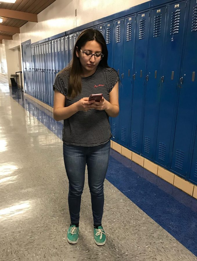 Out of habit students like to take a quick look at their phones as they walk to class, to the bathroom, etc. Veronica Osorio ‘19 checks a message on her phone while in the hallway during class. With the new policy, Osorio would have gotten an automatic referral for simply checking a quick message. “The day the teachers pay for my phone bill, is the day they can take away my phone. Give us back our phones, I miss her!!” Osorio stated. 
