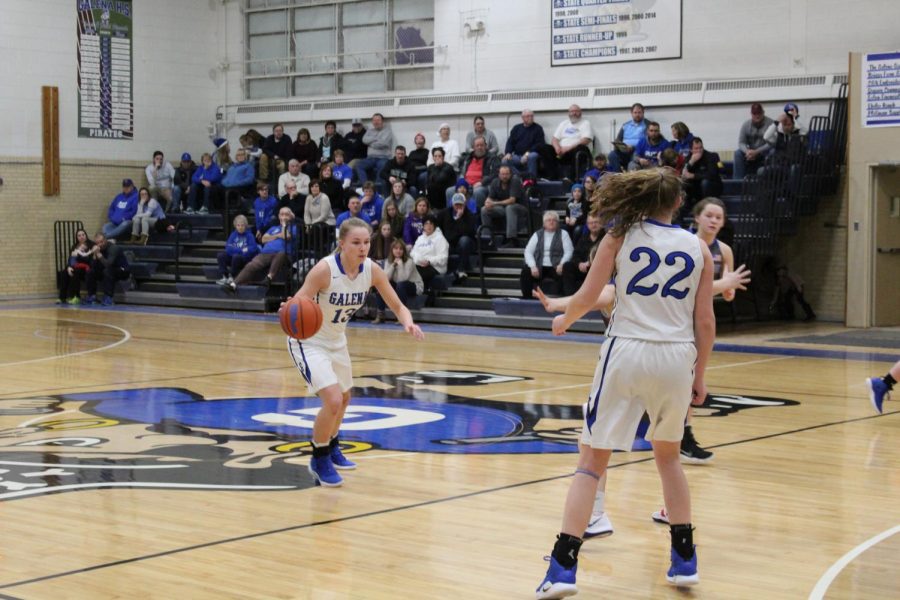 Junior Sami Wasmund takes the ball up the court against the East Dubuque Warriors. The Pirates won with a score of 53-43. Wasmund said, “It was great to get another win under our belt especially with the postseason right around the corner!”
