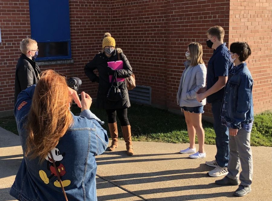 Finding ways to stay safe, the Drama Club begins shooting scenes while remaining socially distanced. Pictured above (left to right), Mrs. Jenkins films Daniel Heid, Mrs. McIntyre, Maya Dickerson, Caleb Soat, and Jovian Pham. Mr. and Mrs. Jenkins have worked hard to make sure that the state the world is in won’t take away the fall play. Mrs. McIntyre stated, “Im sure there will be many hiccups along the way, due to COVID, but they are organized so it will all come together at some point.” The Drama Club has adapted to the changes of the world extremely well and their latest production is sure to be another big hit!