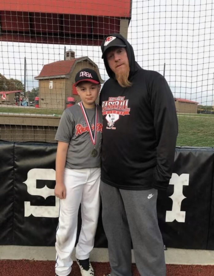 Coach Michael Benson with his son Jaycob Benson after a Sluggers Game. 