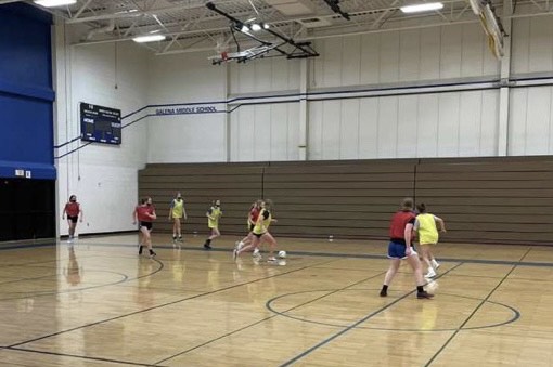 Coach Rijpma snaps a picture during a scrimmage at one of the teams weekly open gyms,” Its really awesome how we all get together and play as a team before the season starts” said Ava Hillard ‘24.