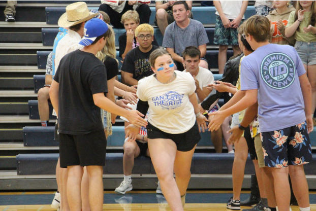 Game time ready! Sophomore Ella Dodds is introduced by Ms. Anderson-Beadle before the powderpuff football game on September 19. Dodds has been part of each year she could, “I really love that I have this opportunity to play.”