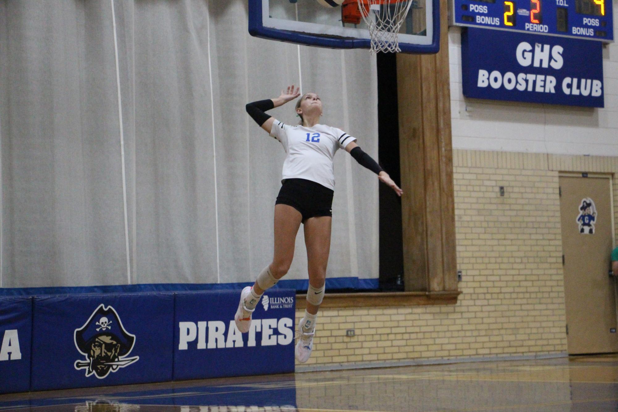 WATCH OUT! Mya McCoy ‘26 jumps in the air preparing to dish out an ace for the Pirates. 