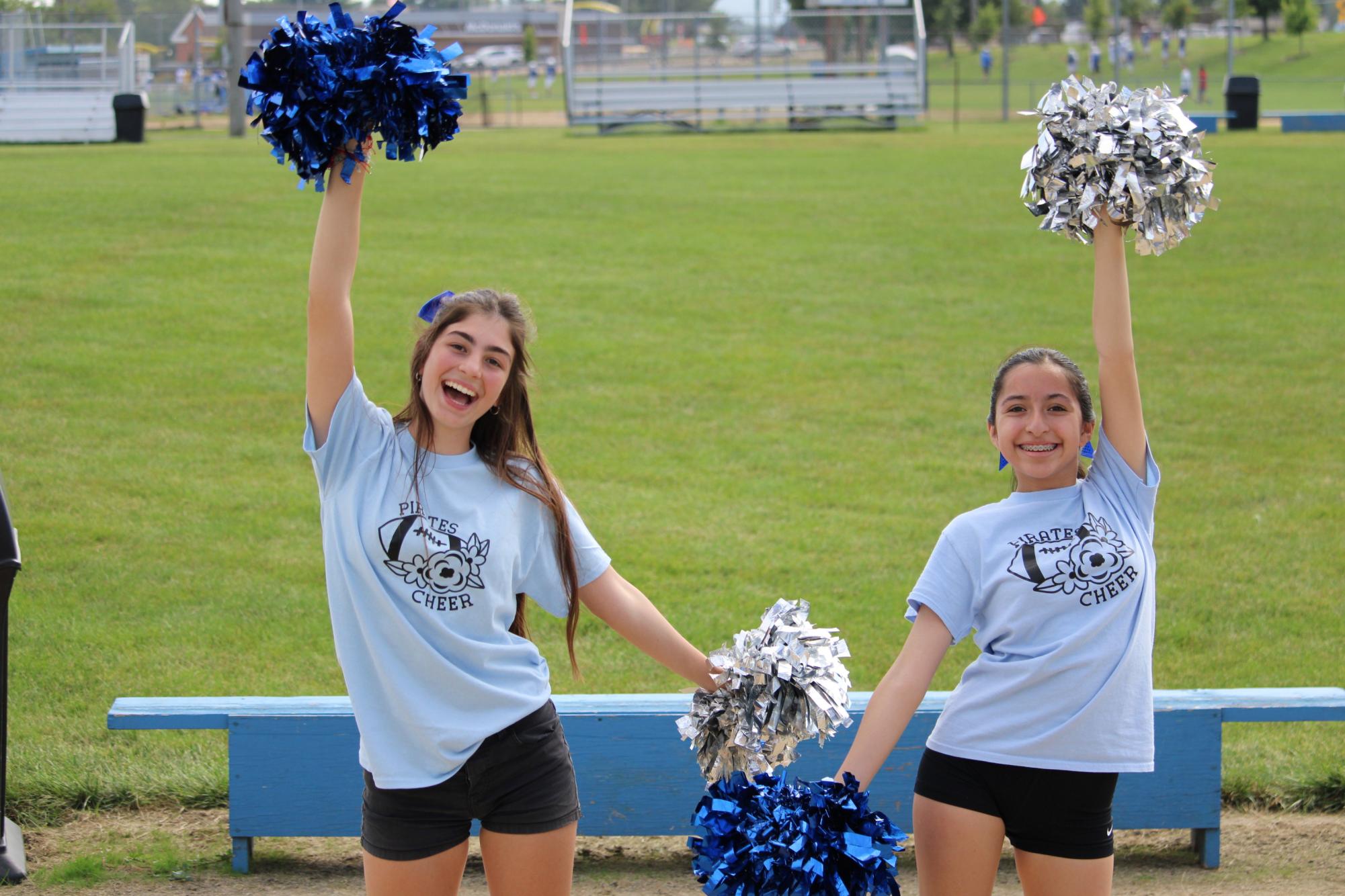 Boosting school spirit! Freshmen Mia Ortega and Senior Cata Mauro practice sideline cheers together before the first football game on August 30. The Cheer team practices everyday after school. Ortega said, “Cheer has been a huge part of freshman year already, I love it!”
