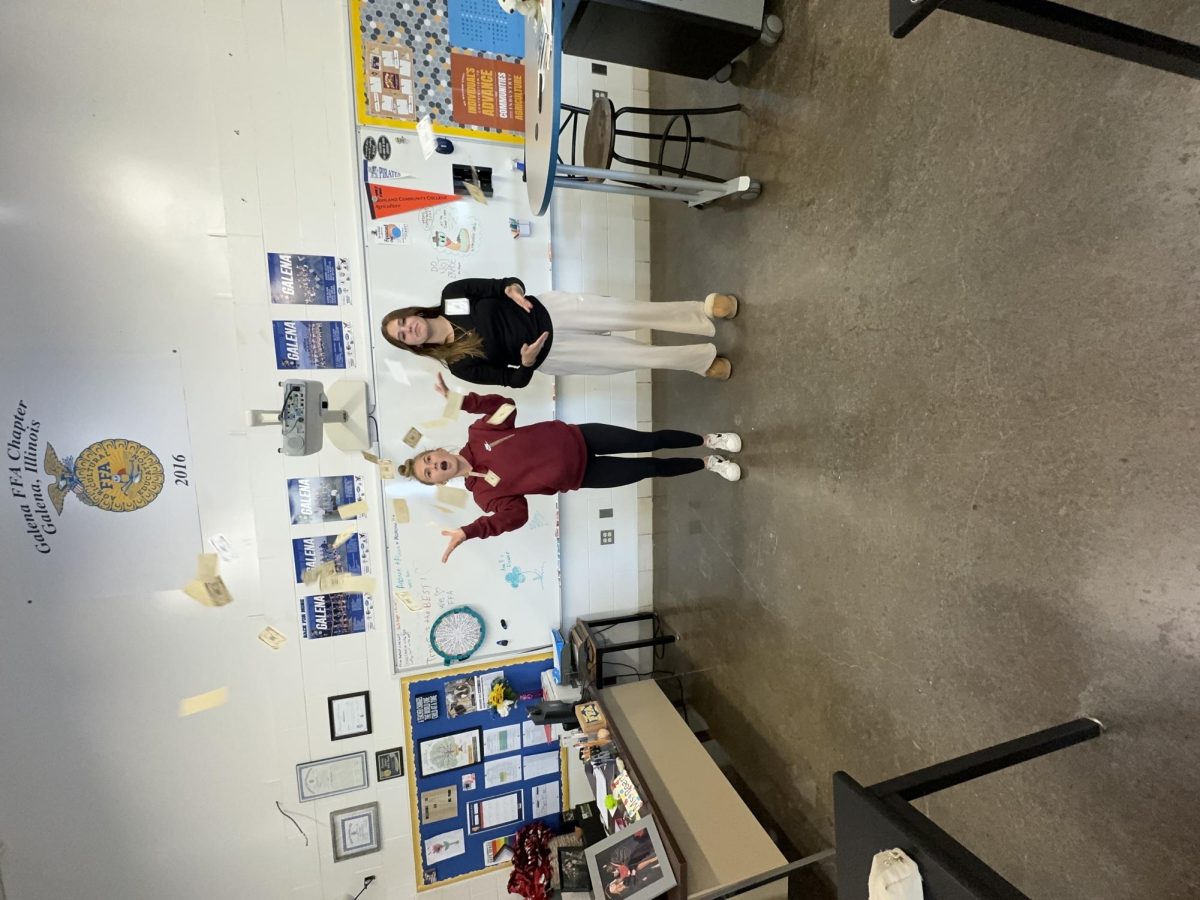 Ell Law and Cameron Einsweiler (Camellon) throwing up fake money in the AG room. “We were just celebrating our amazing article about girl math,” said Camell