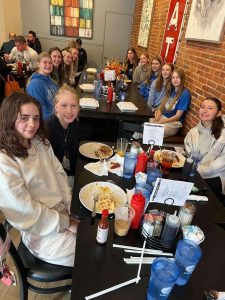 Fueling their bodies, the Galena varsity volleyball players pose for a photo after finishing up their scrumptious breakfast food from Charlies Place. "It was a great way to get together and get some good food before our big game!" Jayme Frank '26 shares. 