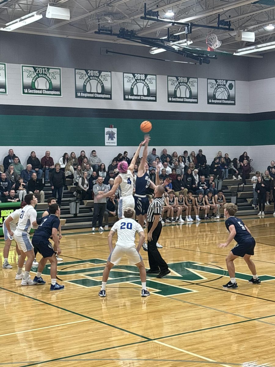 BOYS BASKETBALL IS BACK. Roman Romer ‘26 jumps off for the first game of the Galena Boys Basketball in the Scales Mound Annual Turkey Tournament. “It was kinda hard to get into the basketball mode after a great run in football, but after the first tip it felt great to be back,” said Romer.