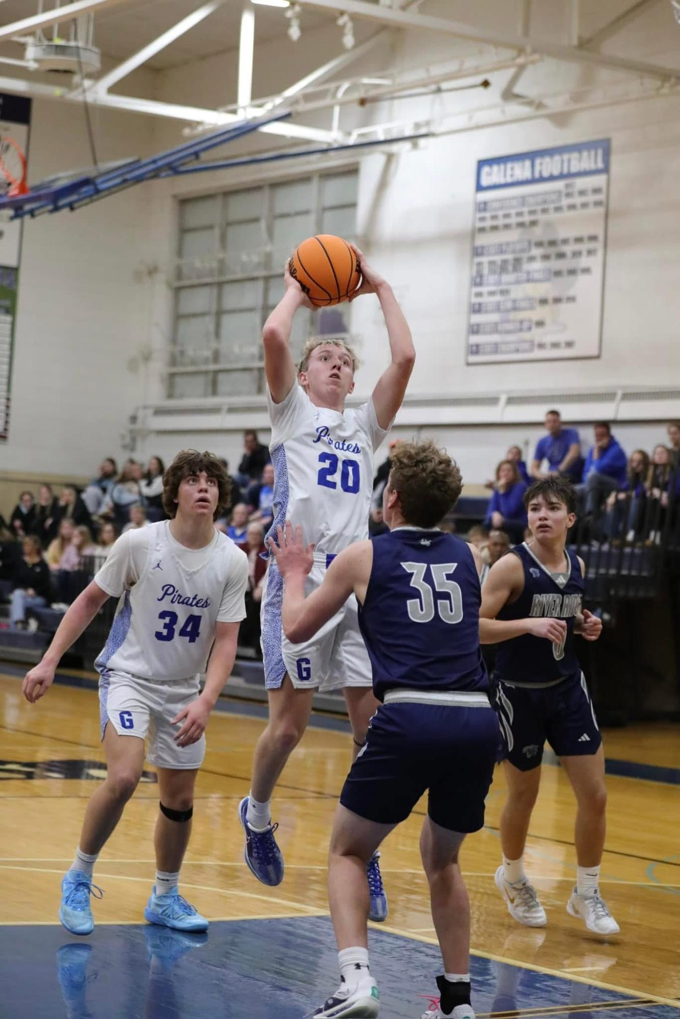 Owen Hefel 26’ Steps close to the corner of the free-throw line, attempting (and completing) a successful jump shot. Next to him is Drew Koenigs ‘26, positioned in the upper middle of the court, anticipating a potential rebounding opportunity. Coach Weinen said “I thought the team played hard all game. I thought our man defense in the 4th quarter was pretty good. We made enough baskets at the end of the game to get the win in for our team”