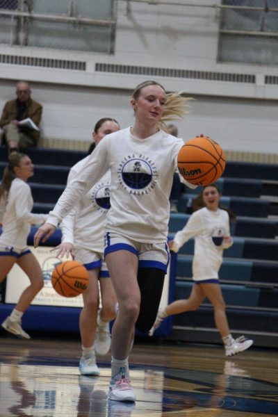 Senior Gracie Furlong ‘25 leads out the team and prepares for their game against the Pretzels.  