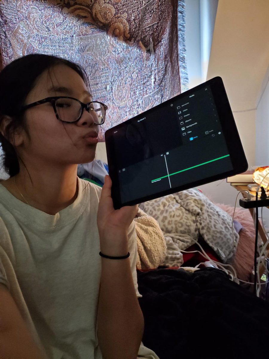 Senior Lily Kern doing her Pubs work on her iPad.“I was working on the Causal Conversation podcast but had to stop because half of my footage got deleted,” she said. 