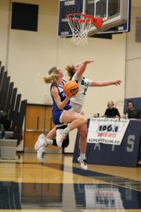 Keep that spirit up! Gracie Furlong ‘25, pictured with the ball in her hands, ready to shoot during the basketball game against Winnebago on February 4th. Furlong ‘25 said, “This was a tough game, but we did our best.” 