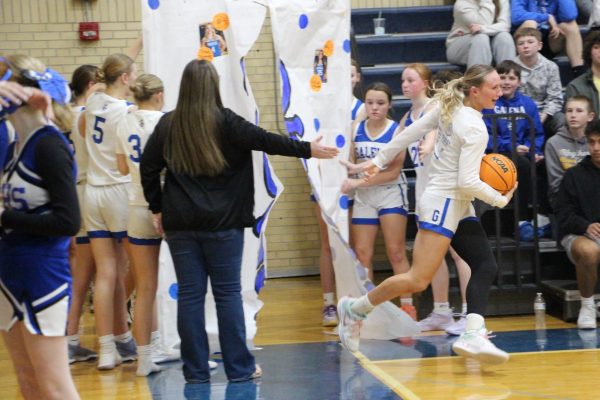 Senior Gracie Furlong, bursting out of the banner, ready for an intense match against West Carroll