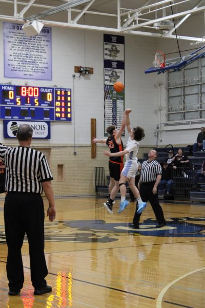 Jump Ball! Drew Koenigs '26 does a jump ball against Warren Player Van Raaitz to start the Varsity Basketball Game. 