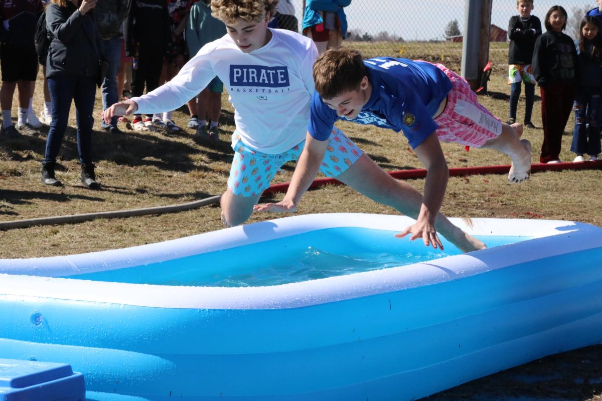 Caption: Full send into the cold! Gus Nack ‘26 and Haadi Khatib ‘28 diving into the polar plunge. “Haadi and I were nervous to jump in,” said Nack, “We decided if we went at the same time we would be ok!” 