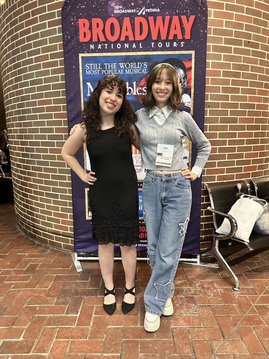 Exceptional players: Liliana Asta ‘26 and Luna Pham ‘27 pose after performing at the 2026 ILMEA All-State Festival. Asta commented that “At All-State, the twelve of us all huddled and encouraged each other, which was a bittersweet moment because we knew that would be the last time we ever sang together in a group.”