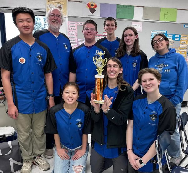 Quizzical: Jenkins and the Galena High School Scholastic Bowl Team pose before a trophy designating him the tournament champion of the Winnebago Scholastic Bowl Invitational. This brings his season record to 29-2, one of his most successful in his entire career spanning over thirty years. In his own words, “My favorite aspect of my coaching career has been instilling in more than 150 team members the idea that learning for learning's sake is a great thing, and that it can be fun!”
